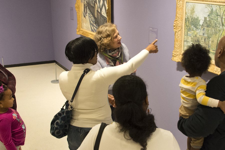 A family discusses a painting with a docent