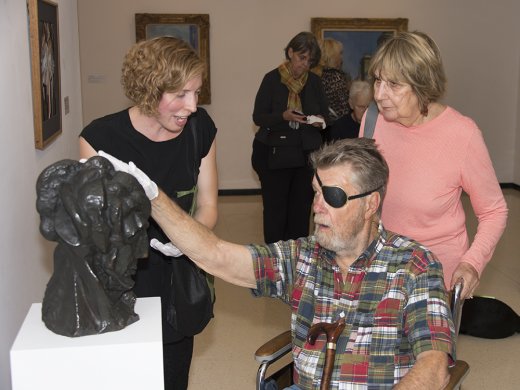 Accessibility and Community Programs Coordinator Teri Fallesen guides a visually impaired guest as part of the Veterans Connecting through Art program