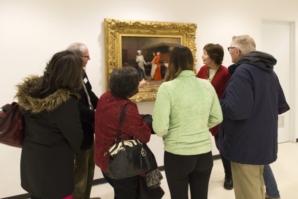 Docent leading a tour in front of Jehan Georges Vibert's The Marvelous Sauce