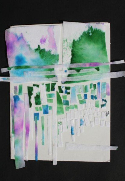 Artwork on white paper with blue, green and purple watercolors and cutouts