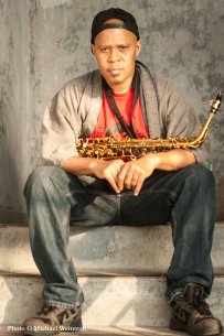 Steve Coleman sitting and holding his saxophone