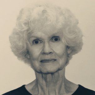 A black and white headshot of an elderly white woman with curly gray hair