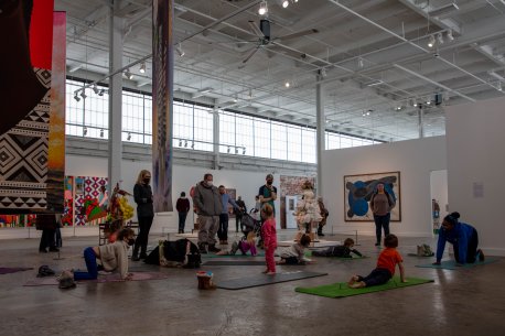 Kids doing yoga in a gallery space