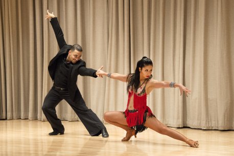 Baila Salsa Dance Company co-founders Calvin Rice and Fanny Olaya dancing on the auditorium stage
