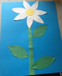 A paper collage of a white daisy