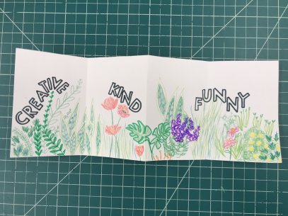 An accordion book with colorful flowers and the words &quot;creative,&quot; &quot;kind,&quot; and &quot;funny&quot;