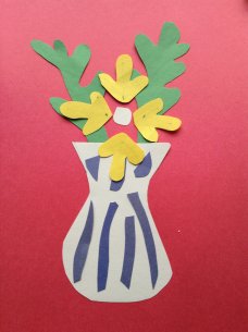 A paper collage of yellow flowers in a blue and white striped vase on a red background