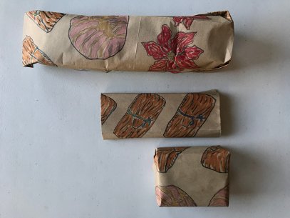Gifts wrapped in brown paper decorated with colored drawings