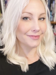 Close up of a woman&#039;s face with long platinum blonde hair