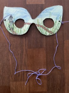 A paper mask with a drawing of a person going on an outdoor walk