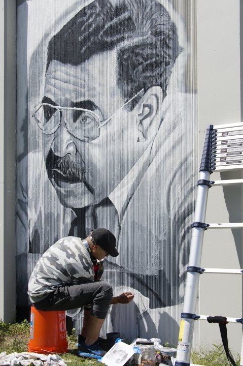 Chuck Tingley working on a portrait of George K. Arthur for The Freedom Wall