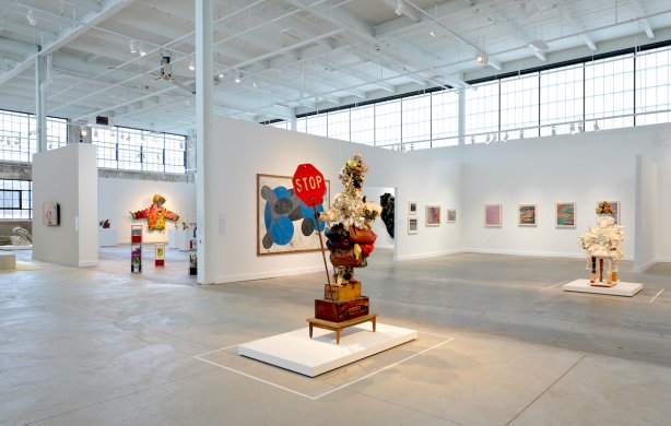 Photo of artworks installed in an open warehouse exhibition space