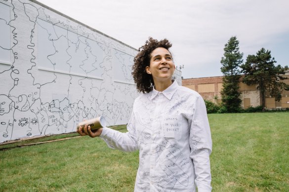 Shantell Martin in front of her mural, Dance Everyday, 2017, at 537 East Delavan Avenue