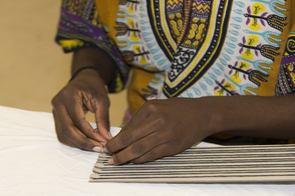 A Black woman's hands making art