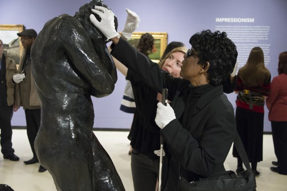 Accessibility and Community Programs Coordinator Teri Fallesen guides a blind woman touching August Rodin's Eve during a Verbal Description Sensory Tour.