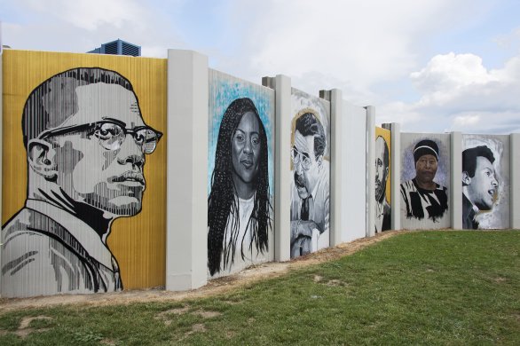 A view of The Freedom Wall in progress. From left to right: Malcolm X, Alicia Garza, George K. Arthur, W. E. B. DuBois, Eva Doyle, and Huey P. Newton. Photograph by Tom Loonan.