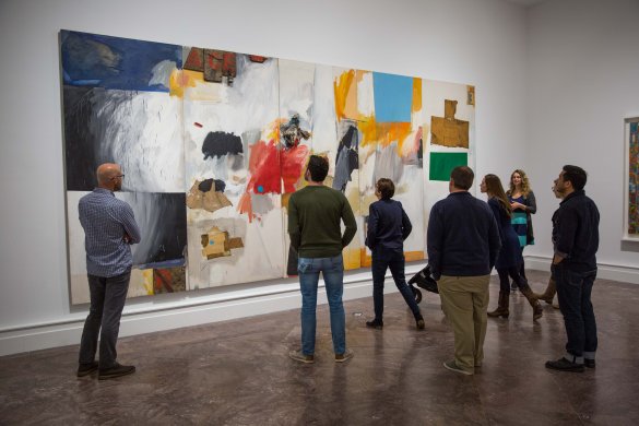 Adults on a tour in front of Robert Rauschenberg's painting Ace