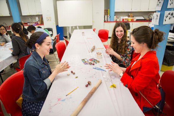 Three young women making art in the classroom