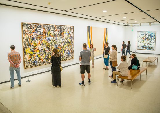 People on a tour in the Lower Level East gallery featuring Abstract Expressionist works