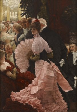A woman in an elaborately ruffled pink dress with a large feathered fan enters an ornately decorated ballroom filled with party-goers on the arm of a much older gentleman. She looks left and outward beyond the viewer, while the attention of nearly all other male figures in the scene is directed at her. The textures of various surfaces and fabrics are painted with rich detail and texture, especially the pink dress ruffles gathered on a plush red ottoman at the bottom of the frame. 