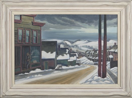 This horizontally oriented painting captures a snowy street scene. A dirt road, lined on both sides by primarily two-story houses, curves downhill from the bottom left corner of the canvas, leading toward a view of snow-covered mountains in the distance. A man wearing a hat and jacket slouches in the entrance to a glass-fronted store on the left edge of the image. In the right foreground, two large brown poles stretch toward the sky.