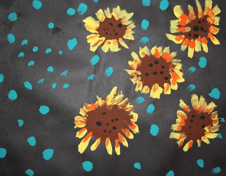 Painting of sunflowers on a black background