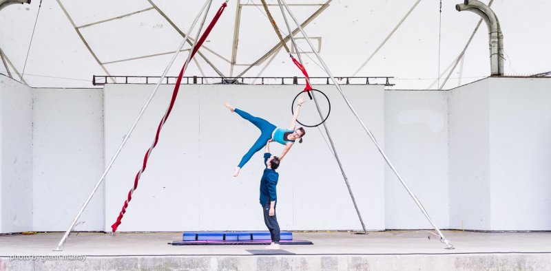 A man and woman doing acrobatics 
