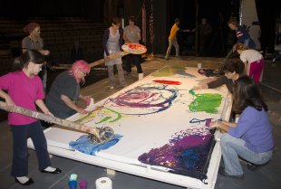 Participants help create one of Charles Clough&#039;s Arena Paintings at Hilbert College
