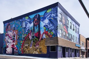 A large mural featuring three Latinx women