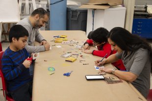 A family making art in the classroom