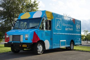 A large blue truck with the words &quot;Art Truck&quot; on the side