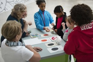 Families explore materials on the ArtCart
