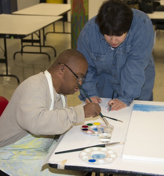 Two young adults making art in a Creative Connection session