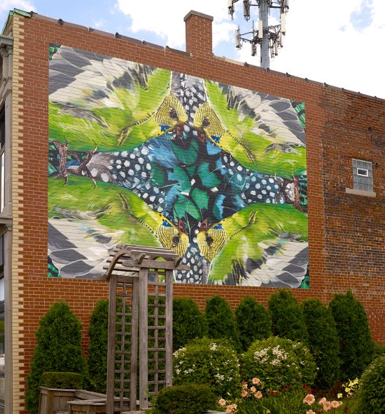 A colorful mural on the side of a brick building