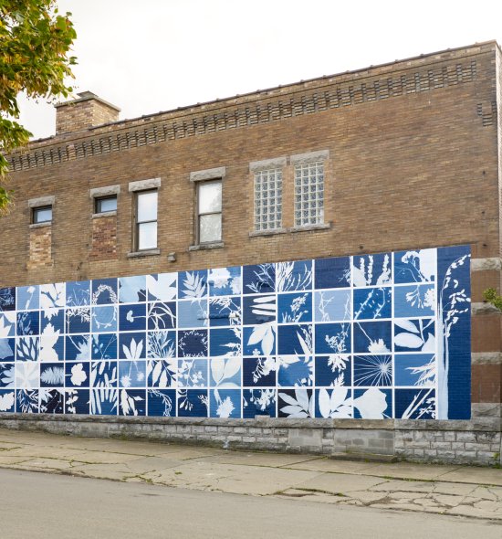 A large mural featuring blue rectangles with white plant forms in each