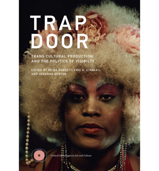 Cover of Trap Door: Photograph of Black person in makeup with white or blonde Afro adorned in pink roses