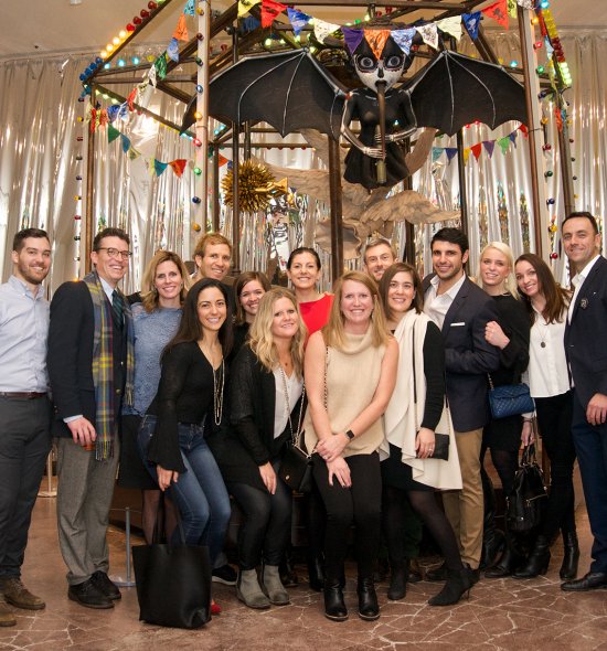 A group of people in front of a carousel