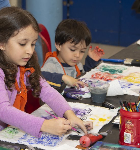 Two children making art
