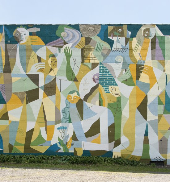 Figures abstracted into a patchwork of loosely geometric forms in shades bright orange, deep turquoise, soft blue, green, and cream fill the façade of a building. Most of the figures appear to be standing, but at center one figure kneels to reach toward a small flowering plant with delicate blue blossoms.