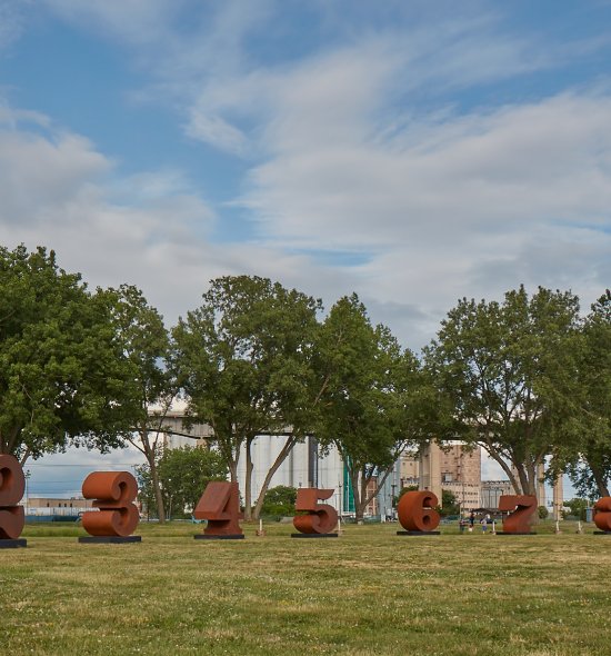 Large brown steel sculptures in the shape of the numbers 1 through 0