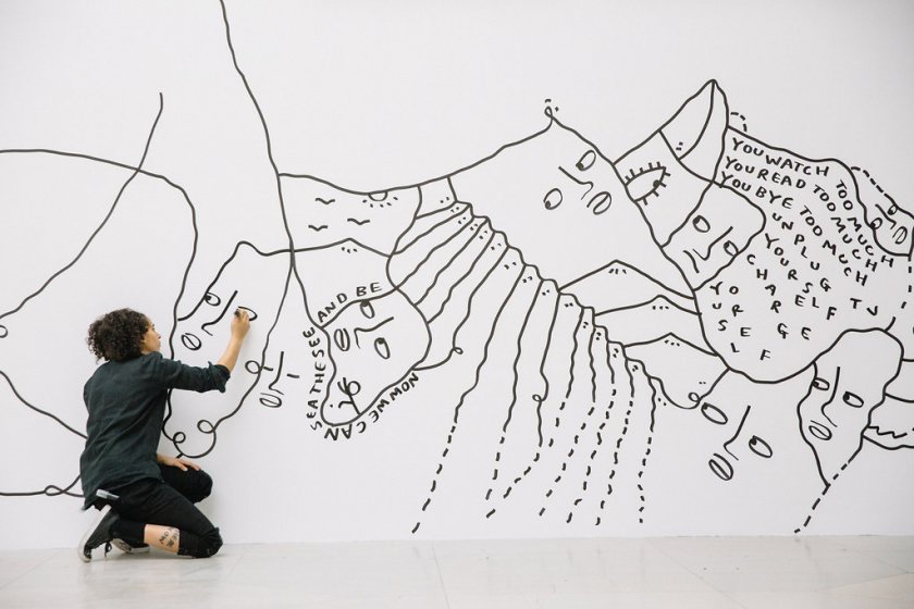 Shantell Martin working on a mural in the Albright-Knox’s Sculpture Court.