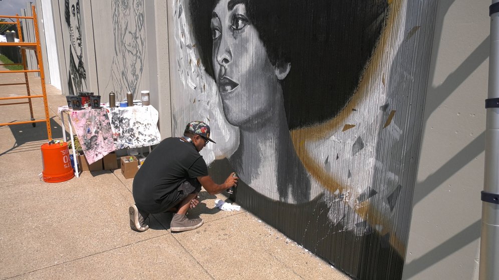 Artist Chuck Tingley at work on a portrait of Angela Davis for The Freedom Wall