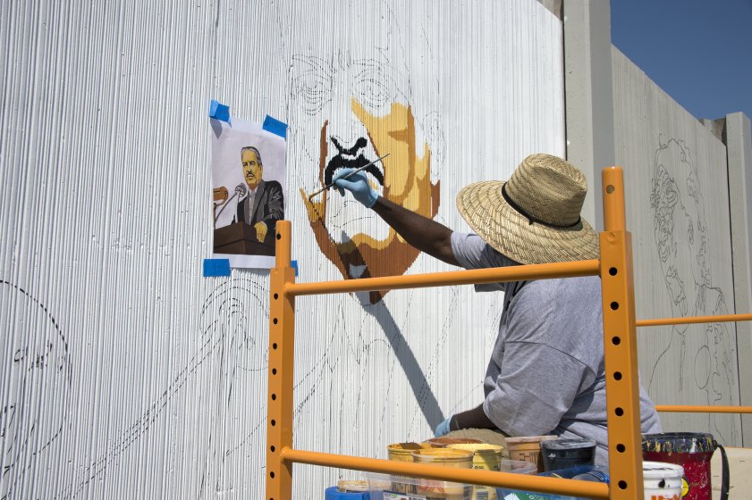 Artist John Baker at work on a portrait of Thurgood Marshall for The Freedom Wall ​